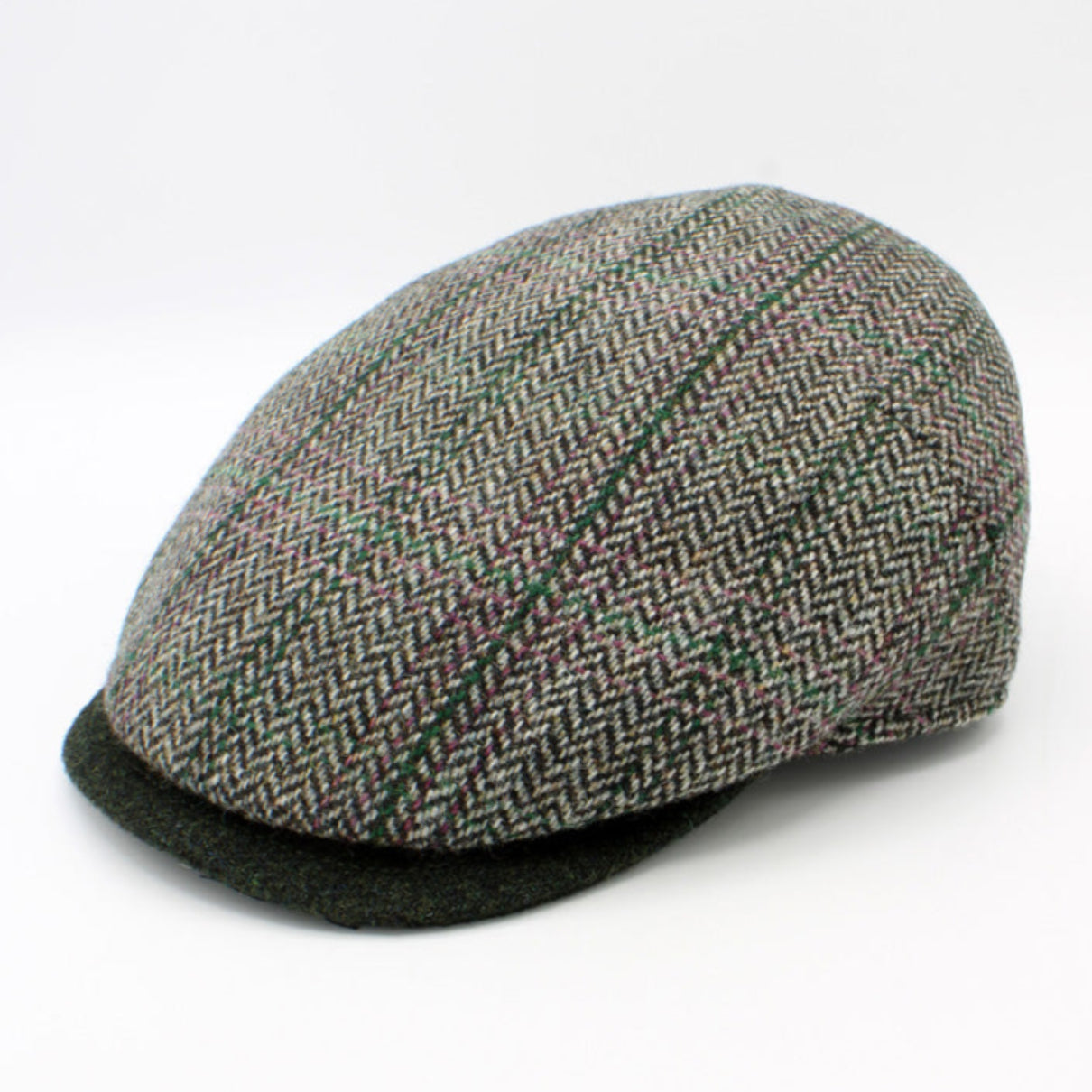 Herringbone patterned flat cap on a white background