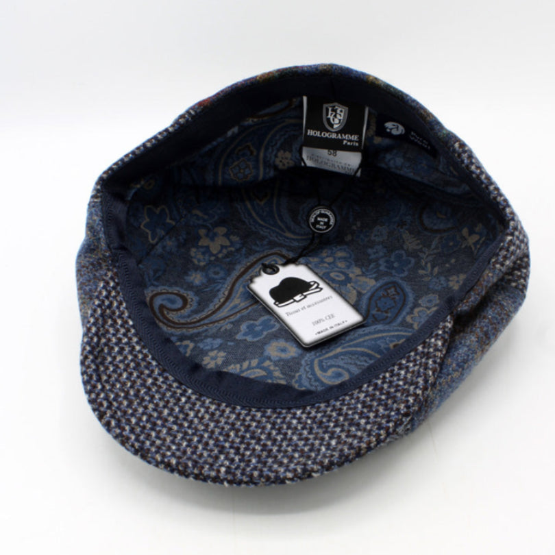 Blue patterned cap with a brand label on a white background