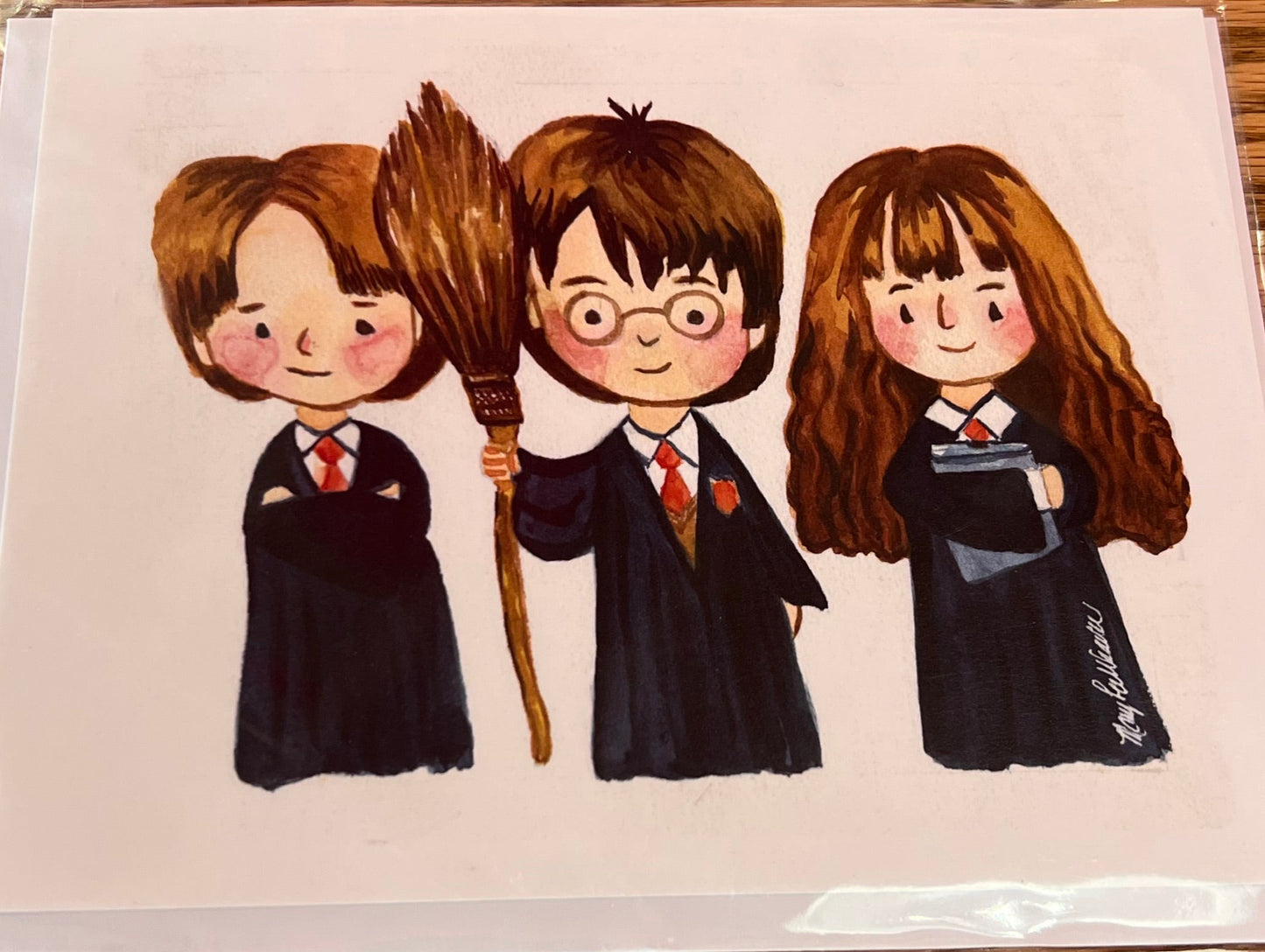 Card with illustrations of four characters on a wooden surface