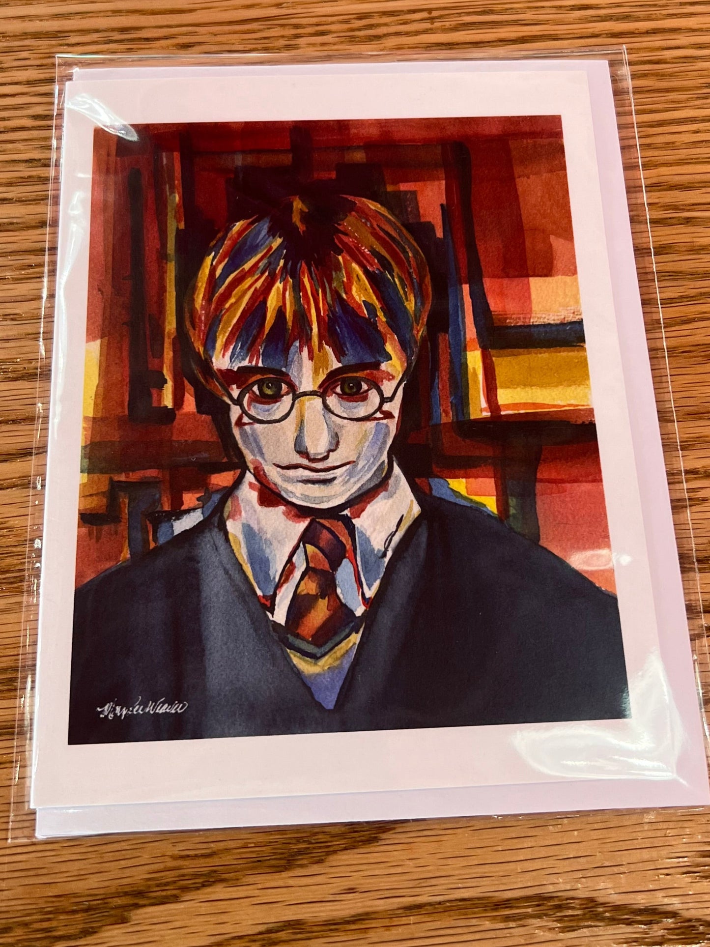 Card with a stylized portrait on a wooden surface